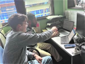 Andrew teaching a Femili PNG staff member how to use the CRM.